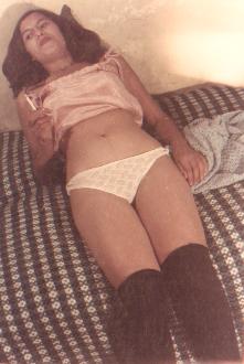 relaxed girl smoker on her bed in her knickers