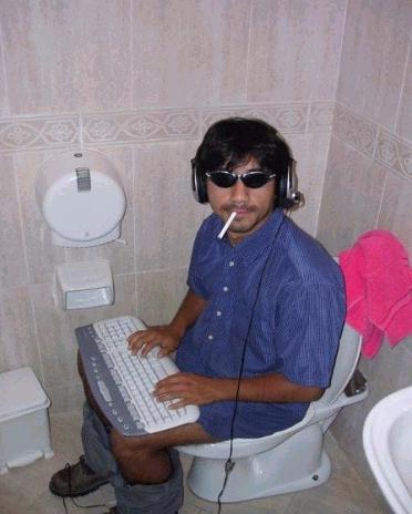 man smoking on toilet with computer keyboard and listening to music on headphones